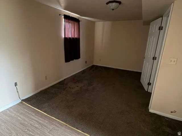 Room with neutral painted walls and a ceiling-mounted light fixture