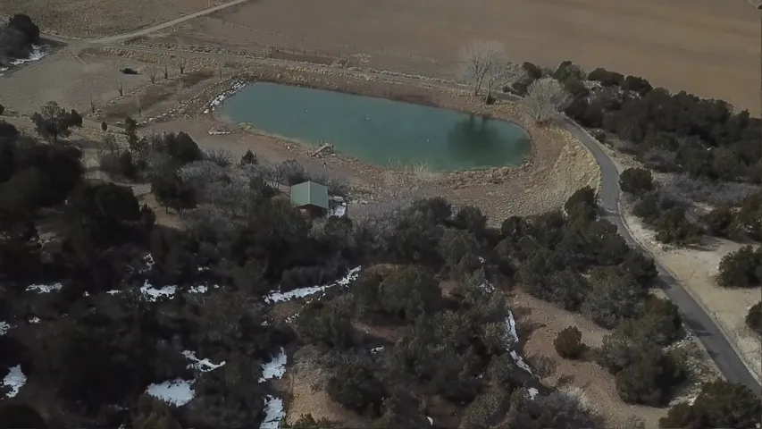 Aerial view of property and surrounding area featuring a large body of water