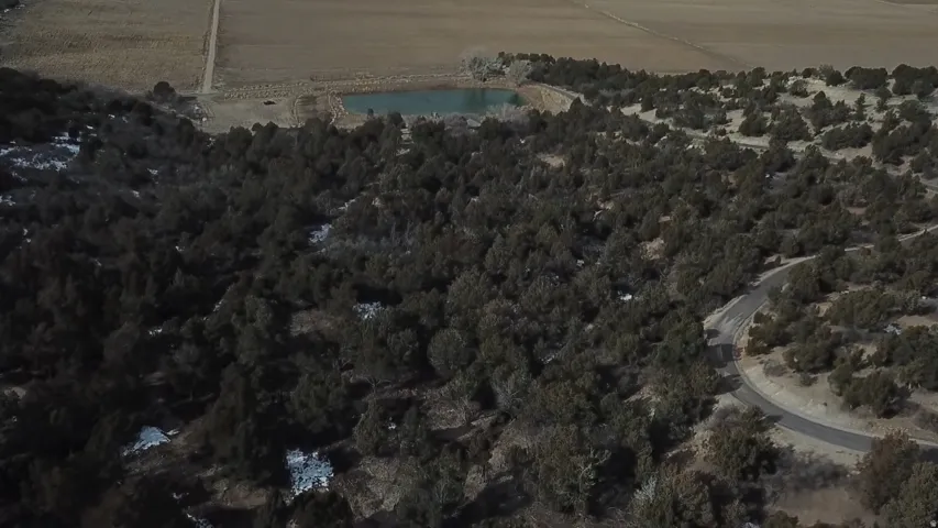 Aerial view of property's location with a nearby body of water