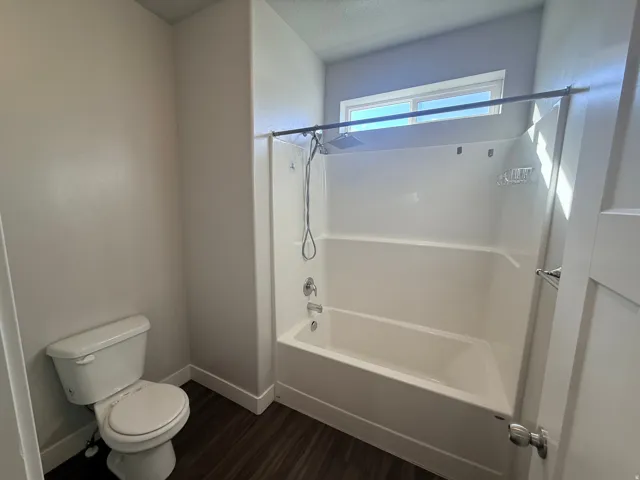 Bathroom with  shower combination and dark wood-style floors