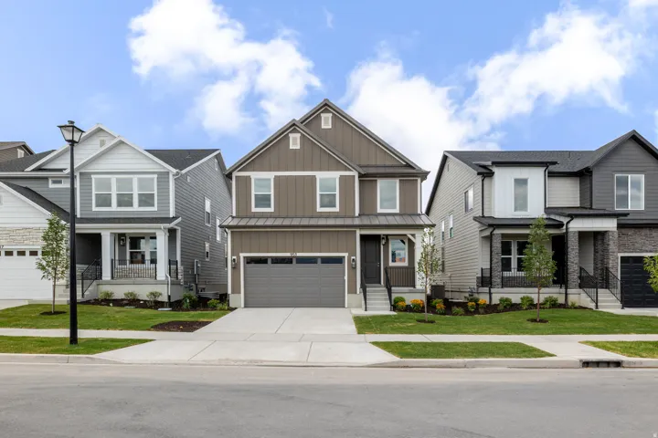 Two-story contemporary residence featuring a two-car garage, board and batten siding, and a covered entry