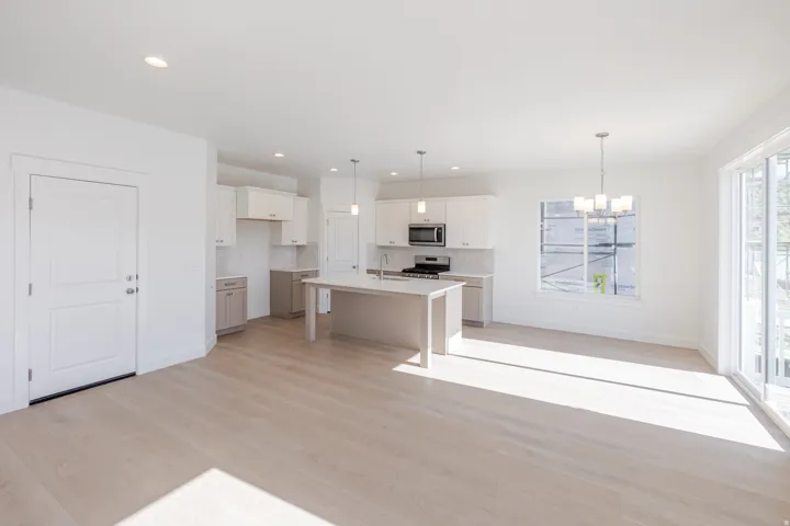 Open-concept living area featuring light wood-finish flooring and recessed lighting