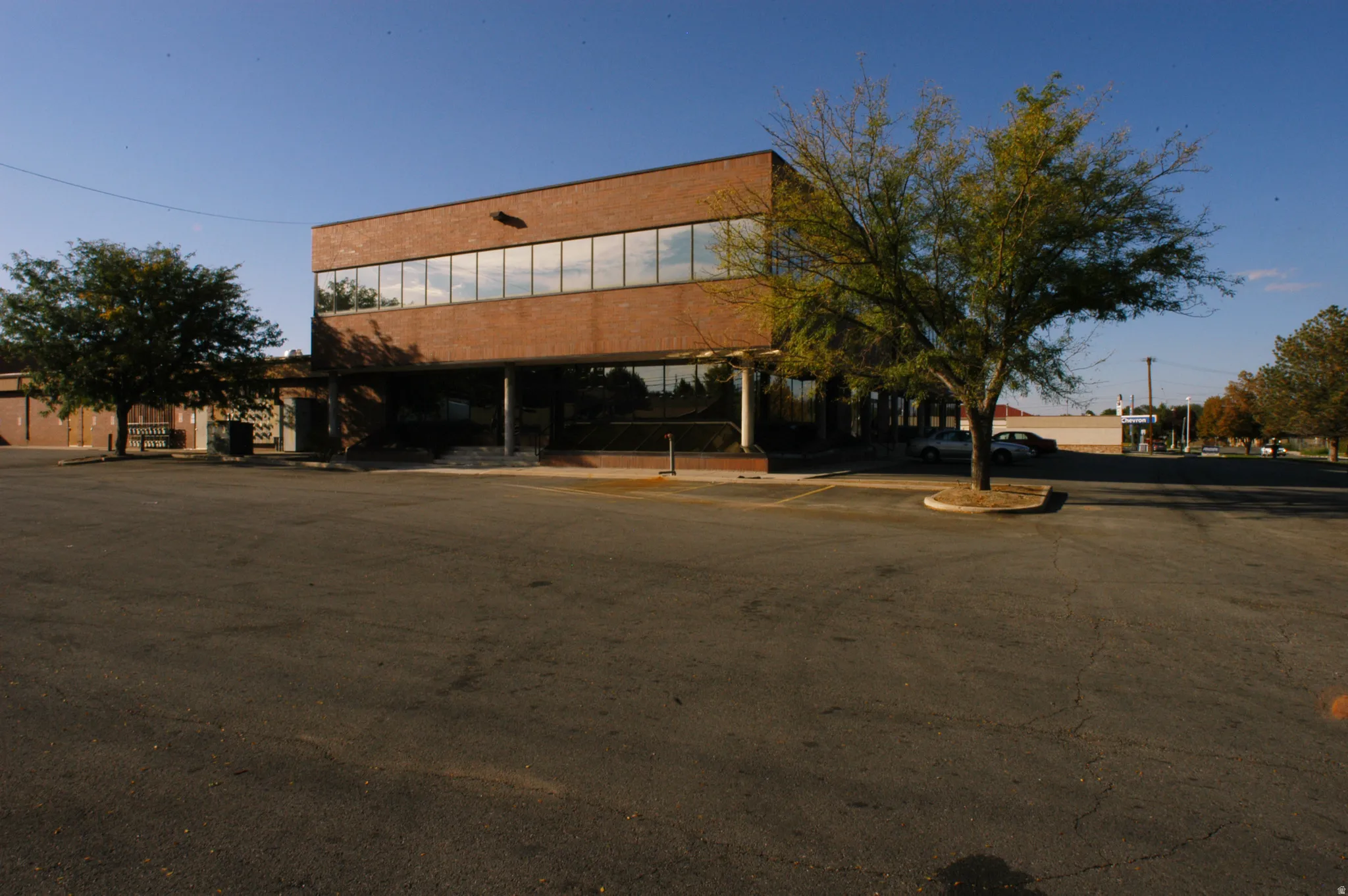 View of building exterior featuring uncovered parking