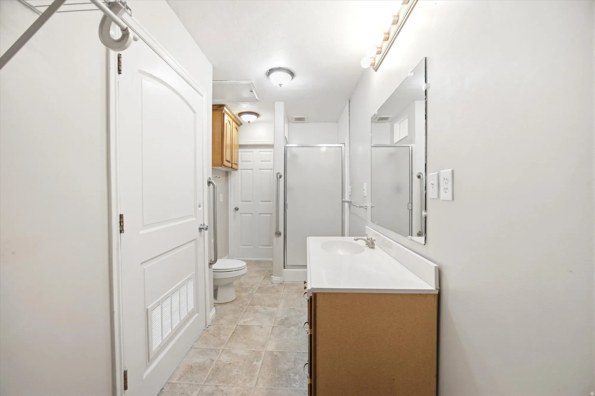 Bathroom featuring vanity and a stall shower