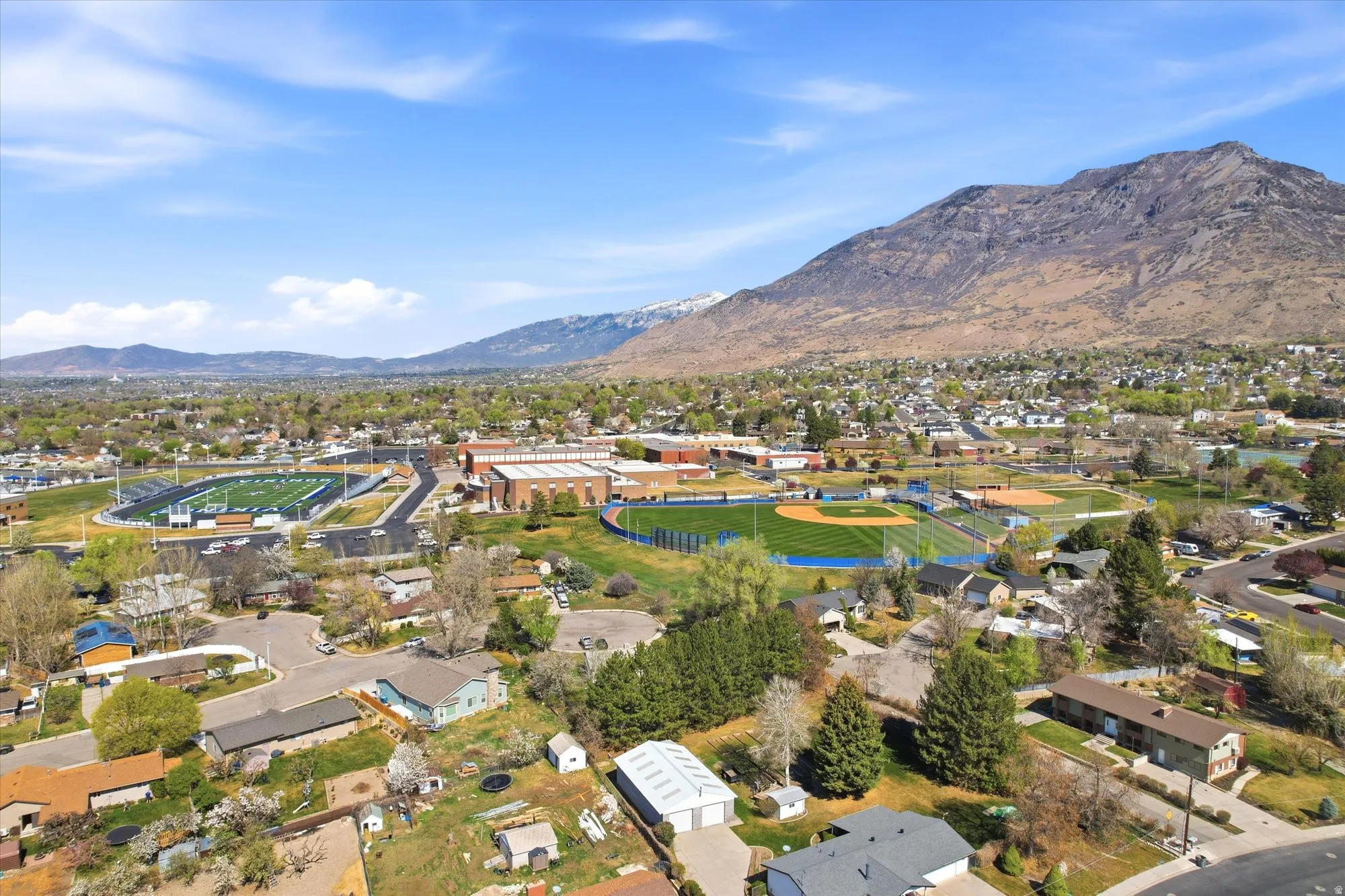 Aerial perspective of suburban area with a mountainous background