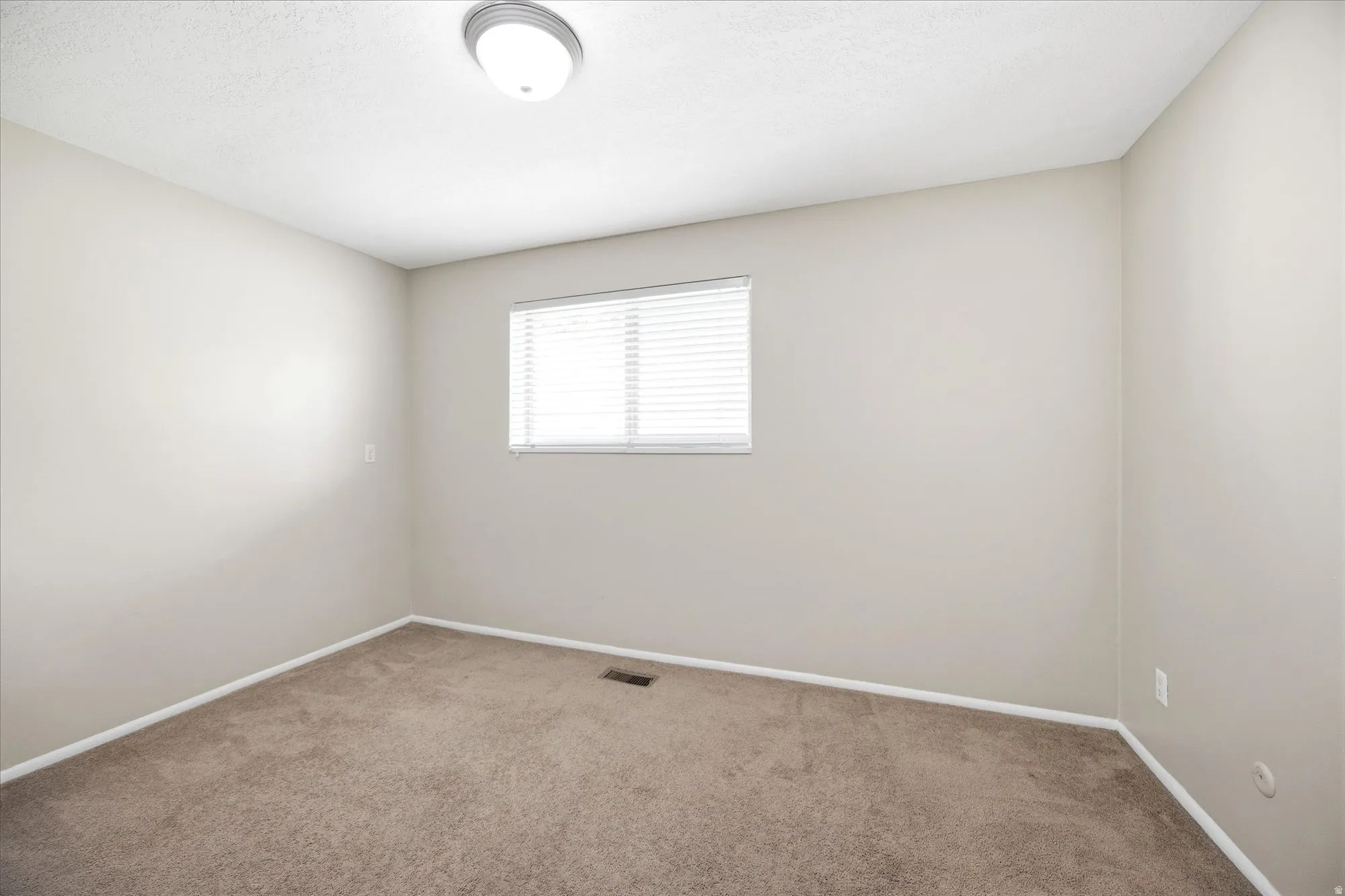 Empty room featuring carpet floors and baseboards