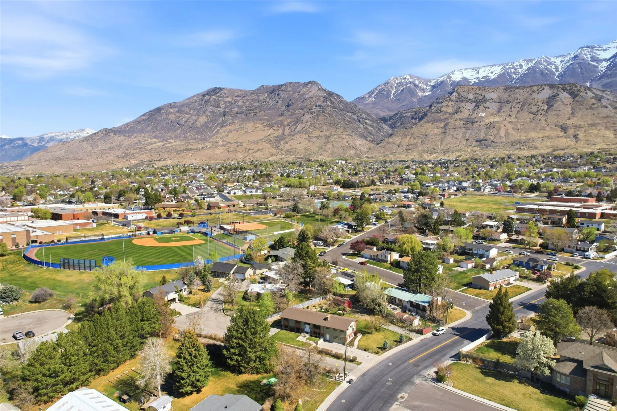 Aerial perspective of suburban area featuring a mountainous background
