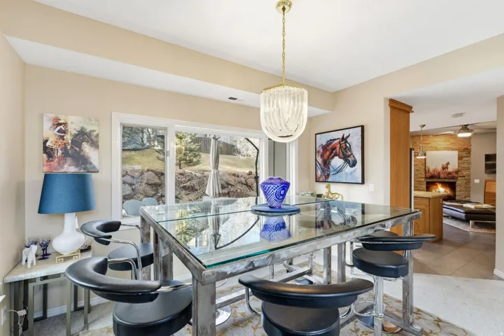 Dining room featuring light carpet and a large fireplace