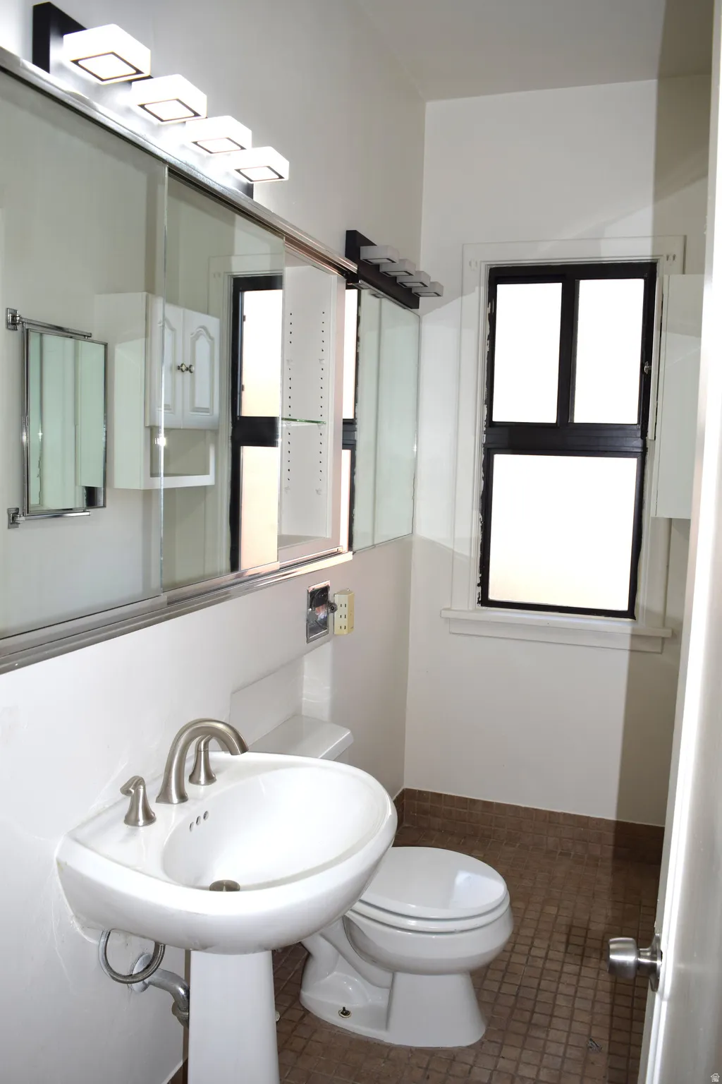 Half bath with toilet and tile patterned floors
