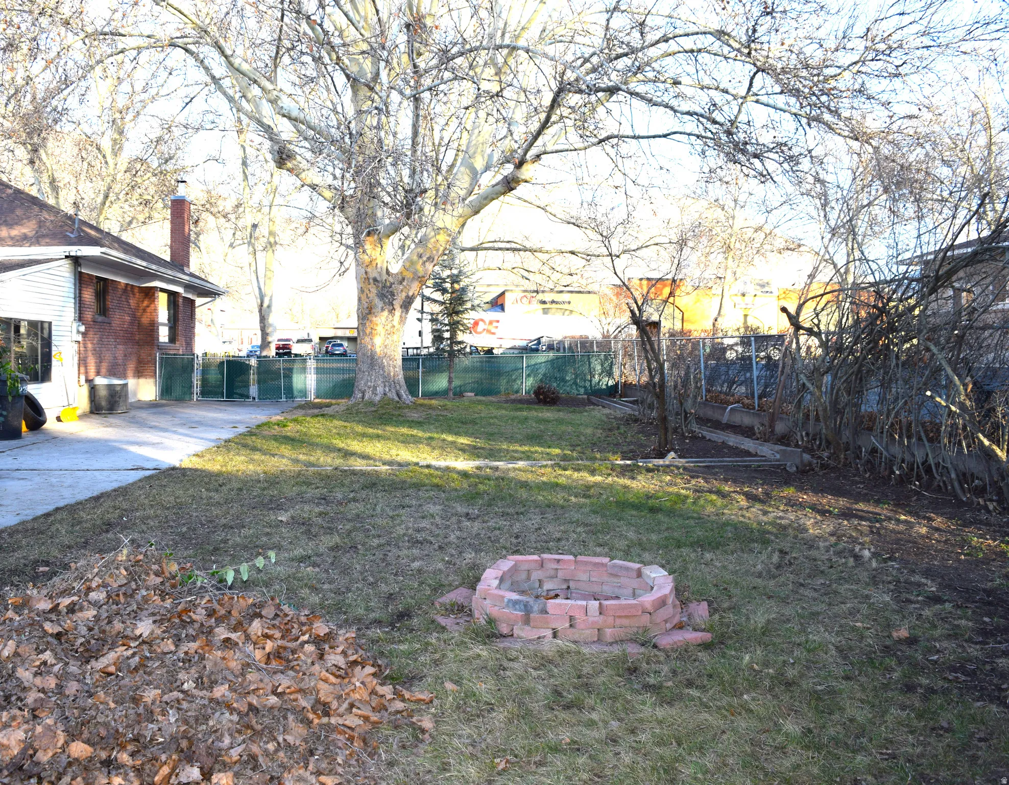 Fenced backyard featuring an outdoor fire pit