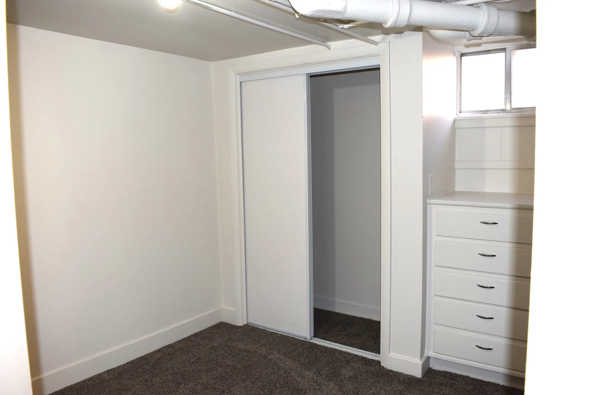 Unfurnished bedroom with dark carpet and a closet