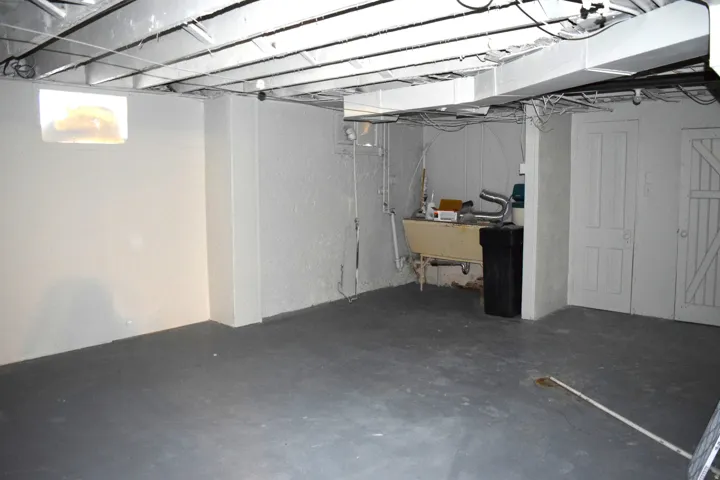 Below grade area featuring a water softener and a sink