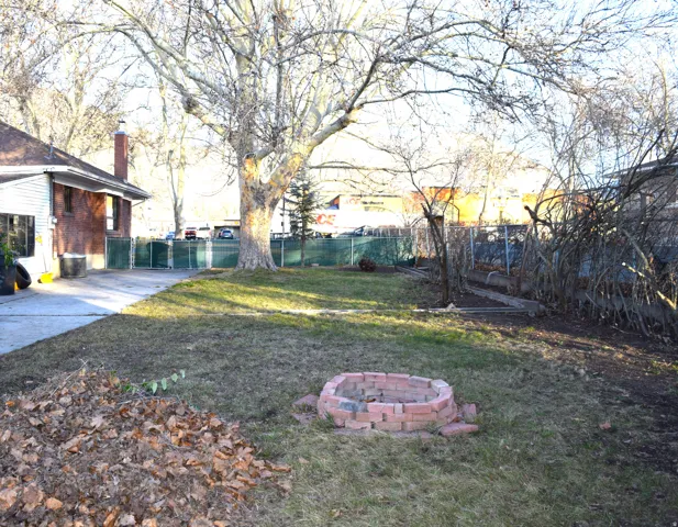 Fenced backyard featuring an outdoor fire pit