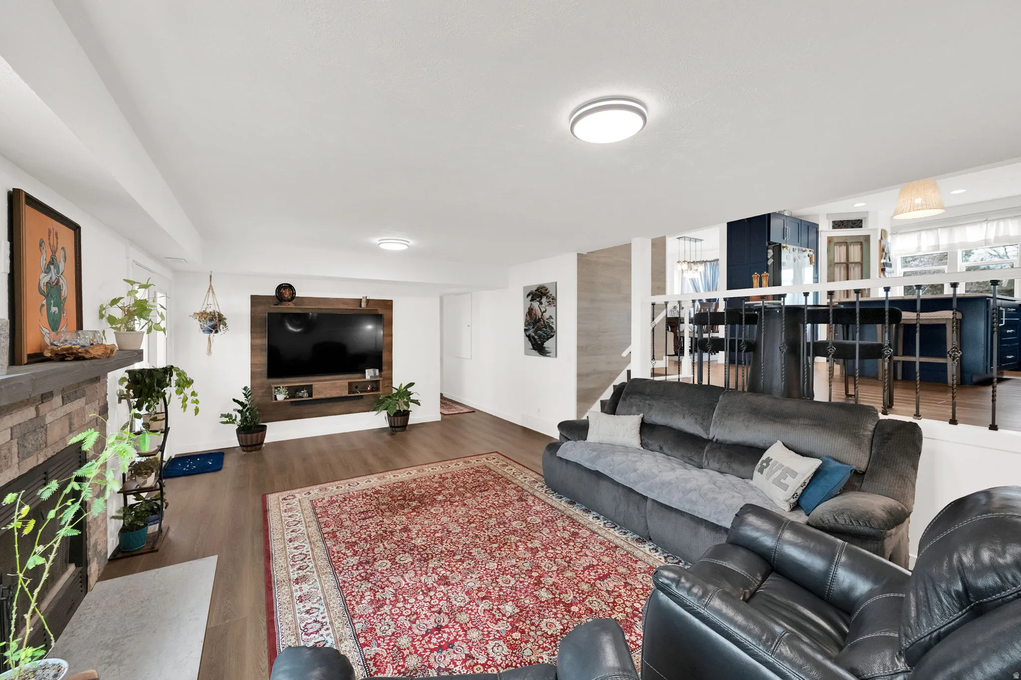 Living room featuring wood finished floors and a fireplace with flush hearth