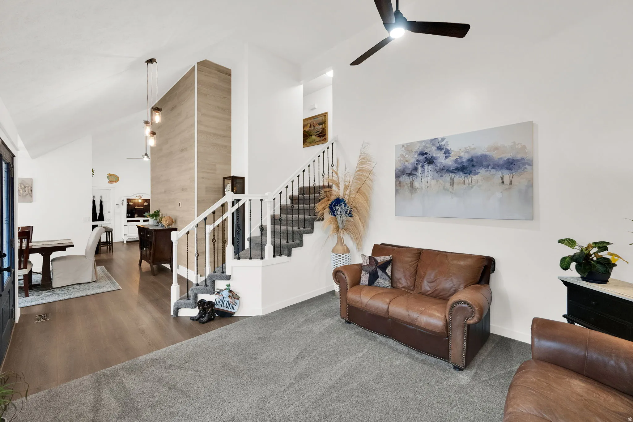 Living room with ceiling fan, lofted ceiling, and carpet floors