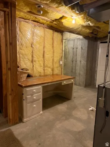 Unfinished below grade area with a heating unit