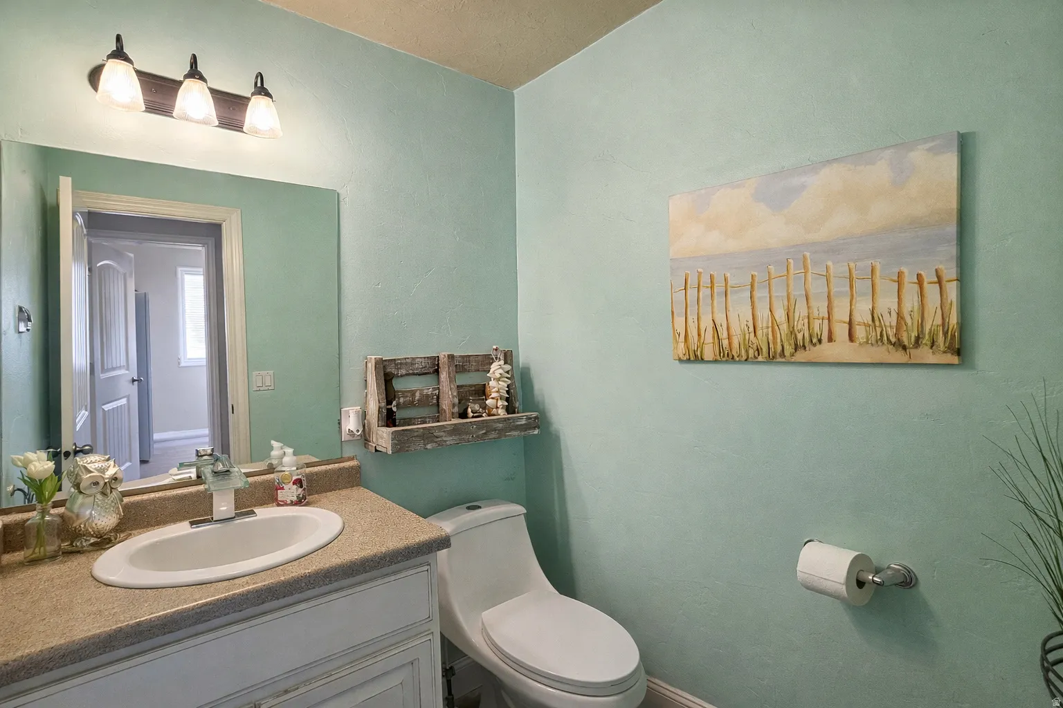 Half bathroom with toilet and vanity