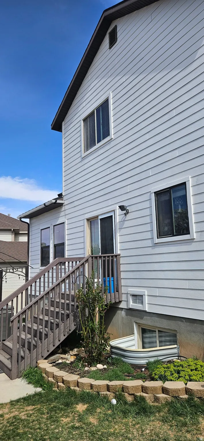 Rear view of property featuring a wooden deck