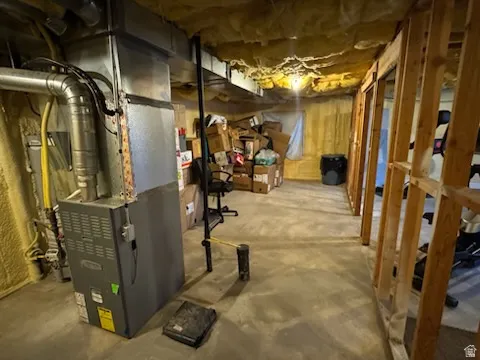 Unfinished basement featuring heating unit