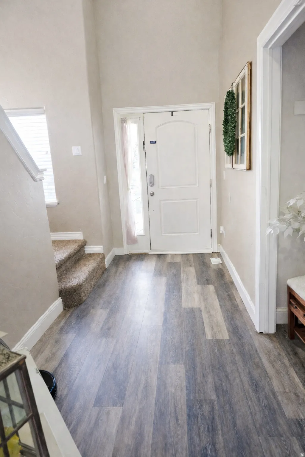 Foyer featuring dark wood-style flooring and a high ceiling