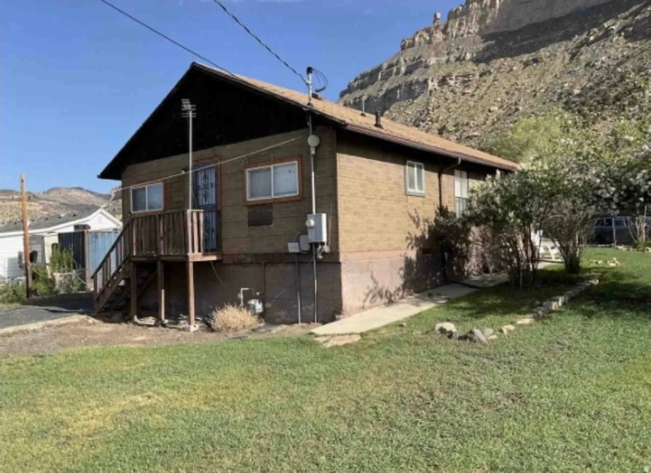 Photo of rear of home during Summer