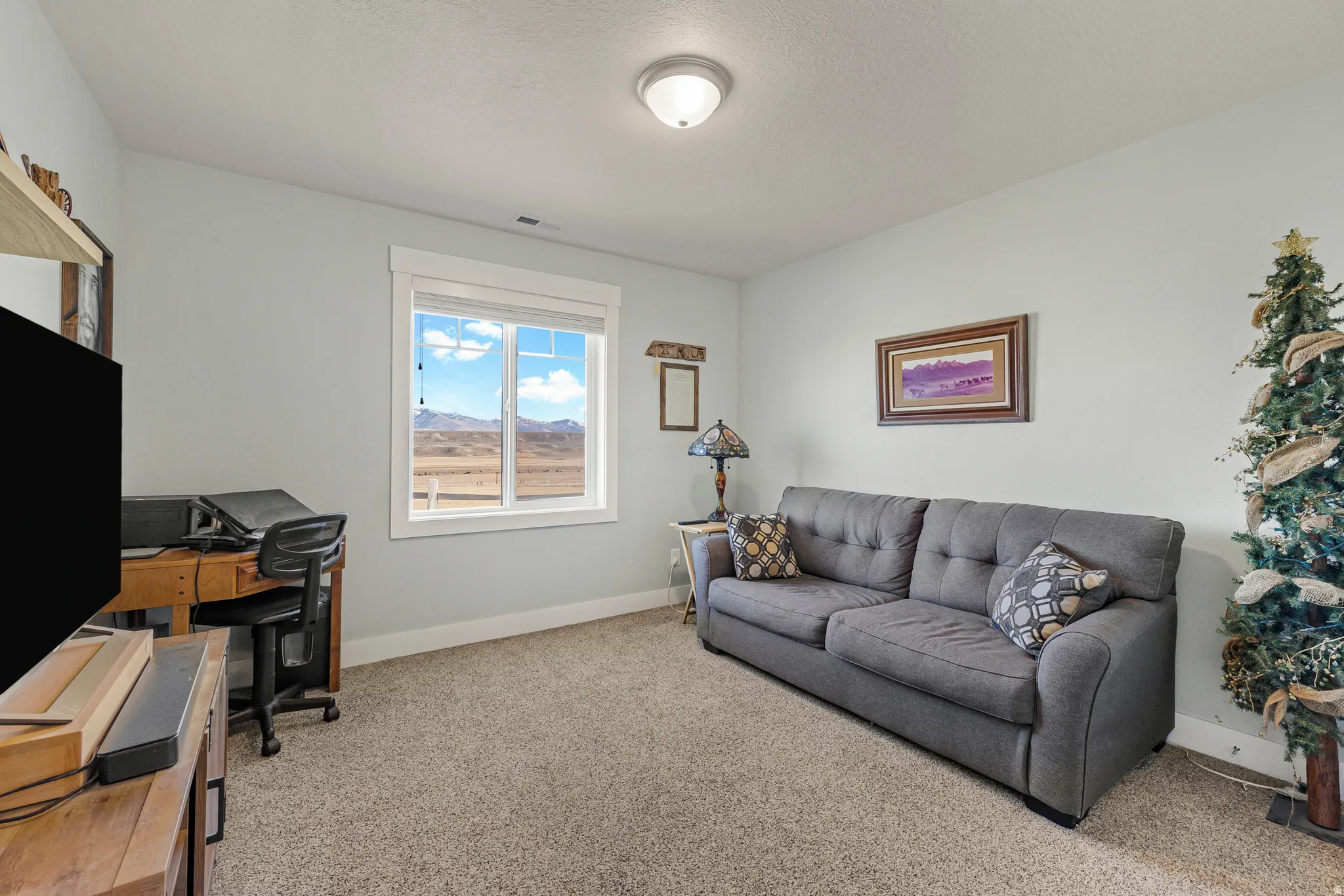 Office with baseboards and light carpet