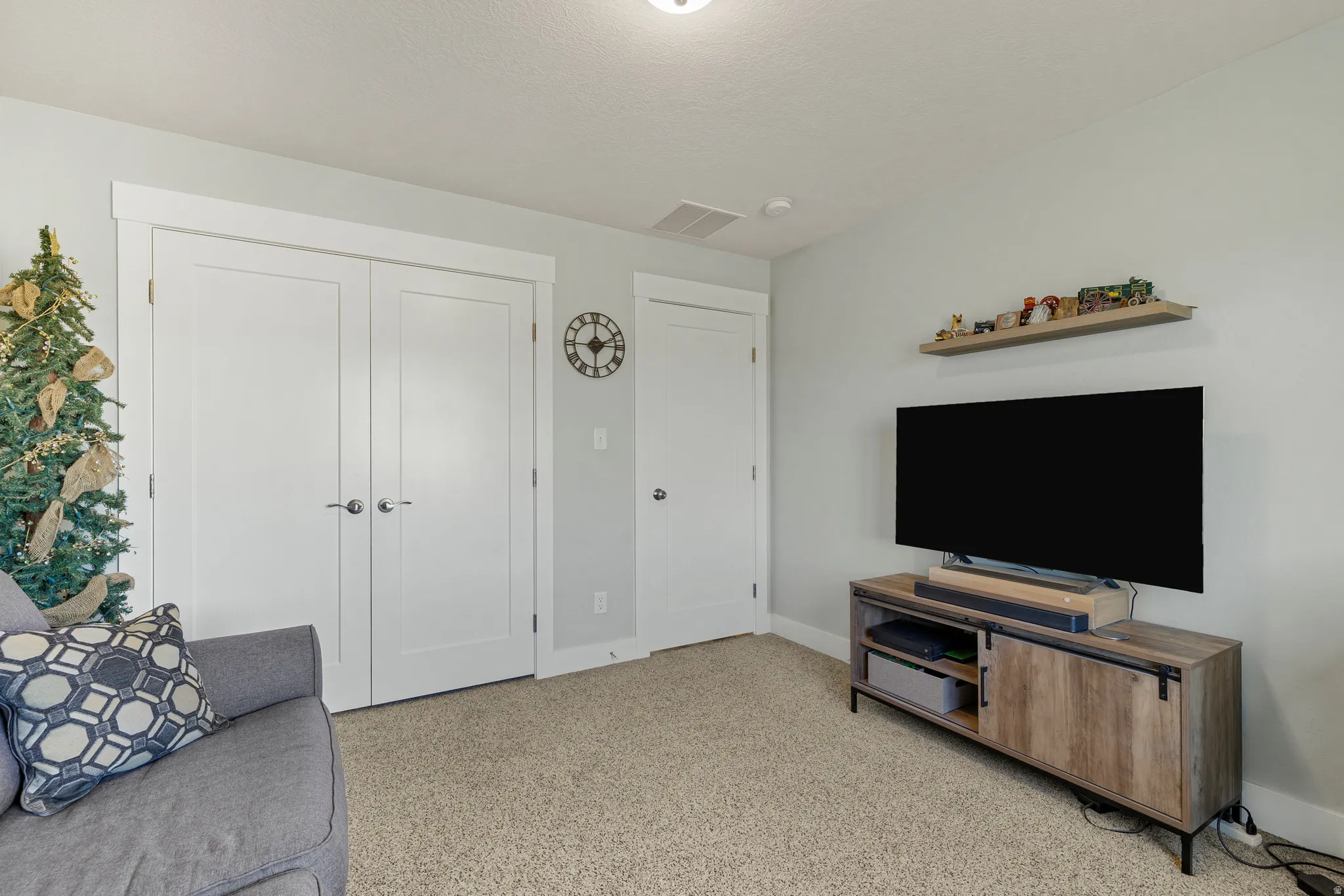 Living room featuring baseboards and light colored carpet