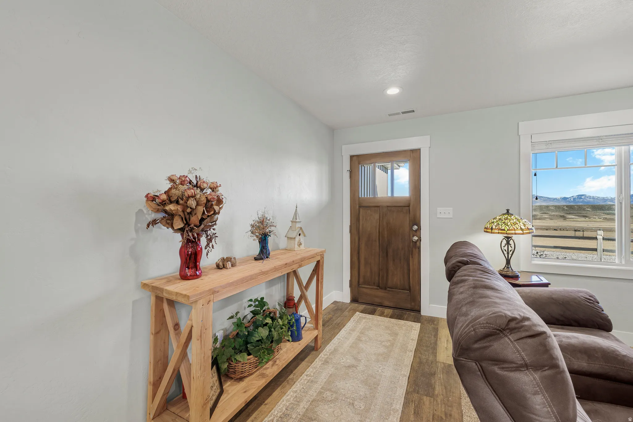 Foyer entrance featuring wood finished floors, a mountain view, and recessed lighting