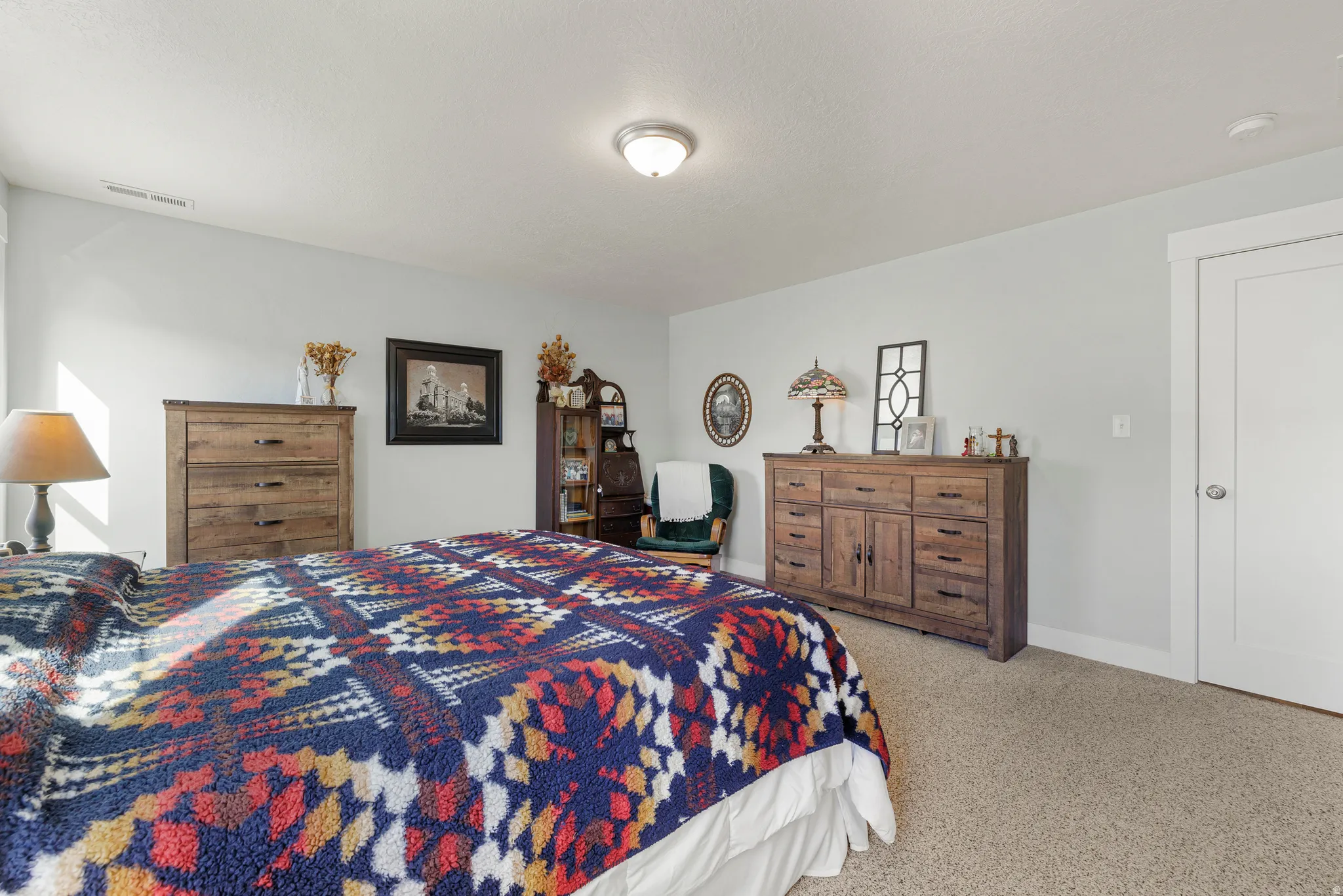 Bedroom featuring light carpet and baseboards
