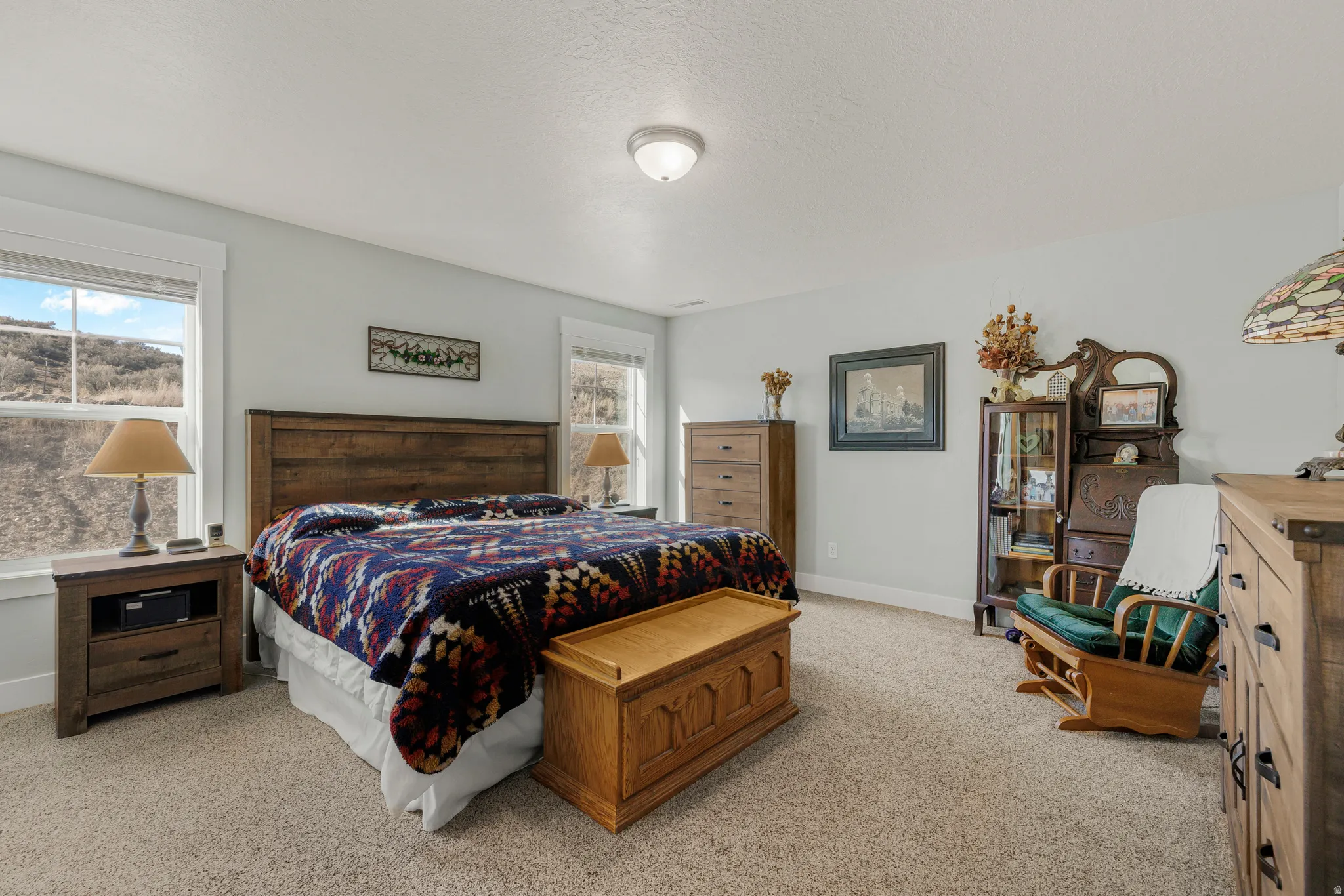 Bedroom featuring baseboards and light colored carpet