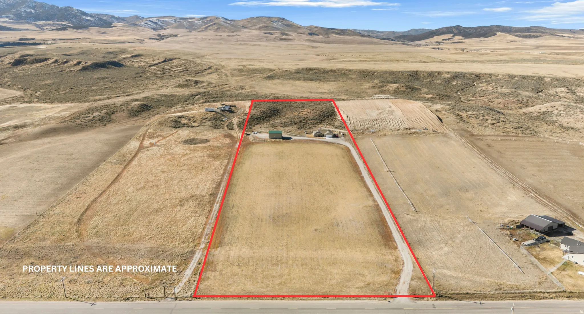 Aerial view of sparsely populated area featuring mountains and property boundaries highlighted