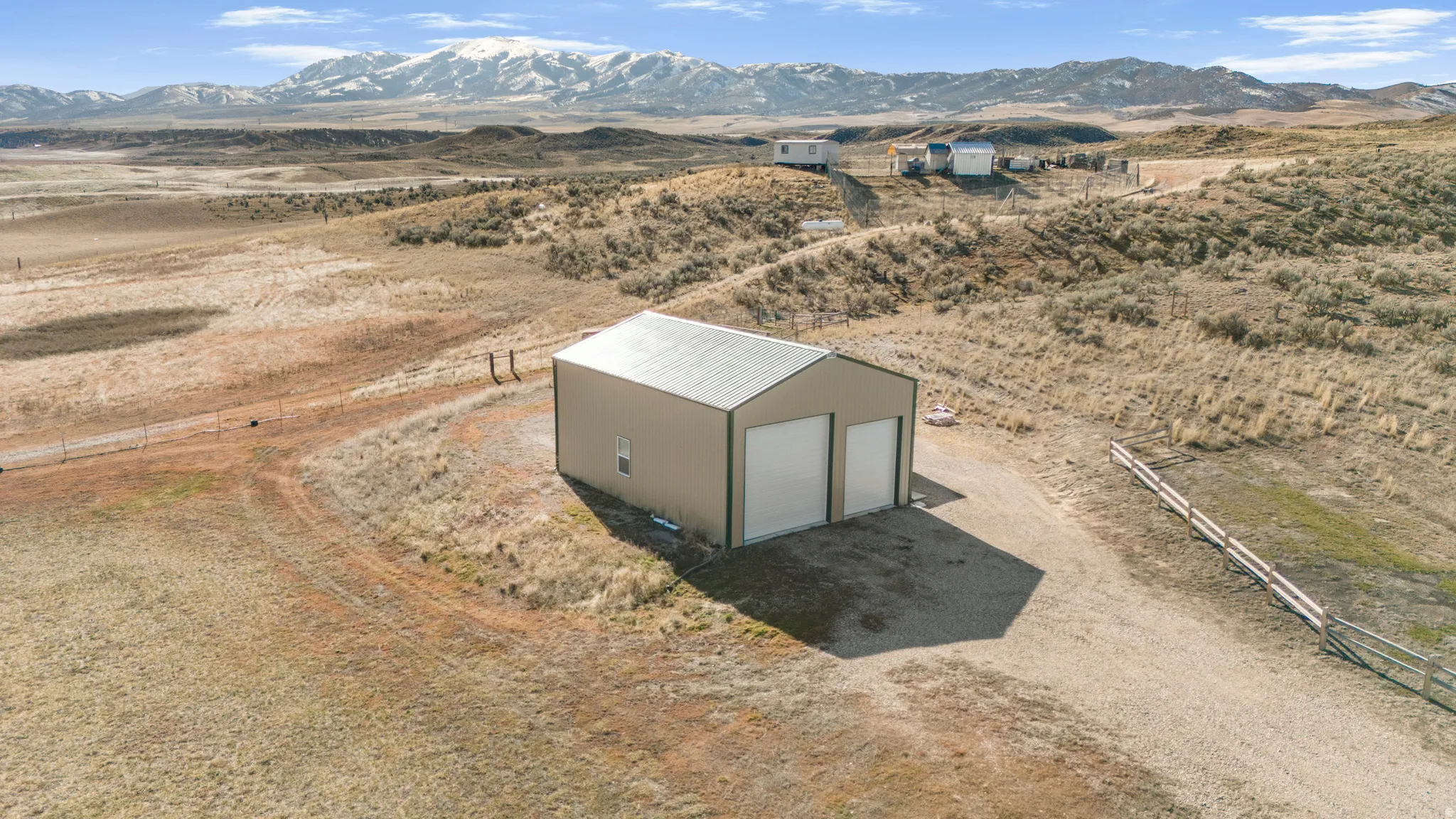 Aerial view of sparsely populated area featuring a mountainous background and a desert landscape