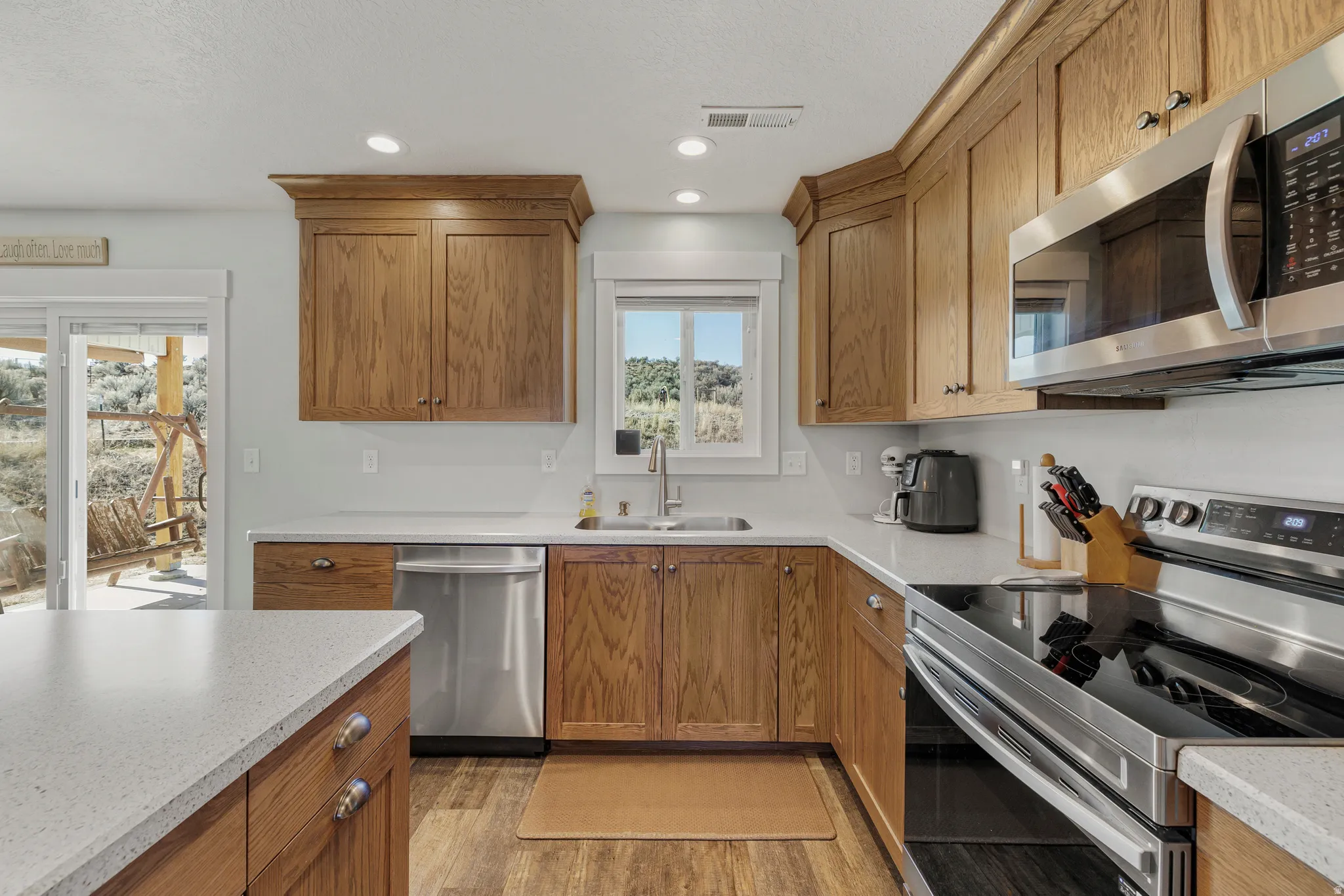 Kitchen featuring stainless steel appliances, wood finish cabinets, and recessed lighting