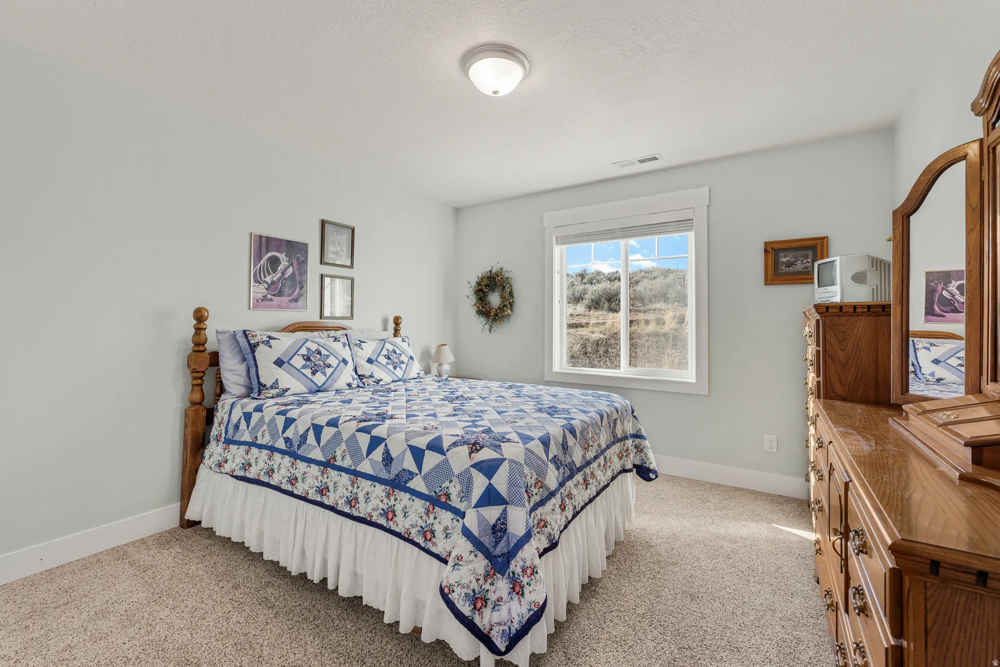 Bedroom with baseboards and light colored carpet