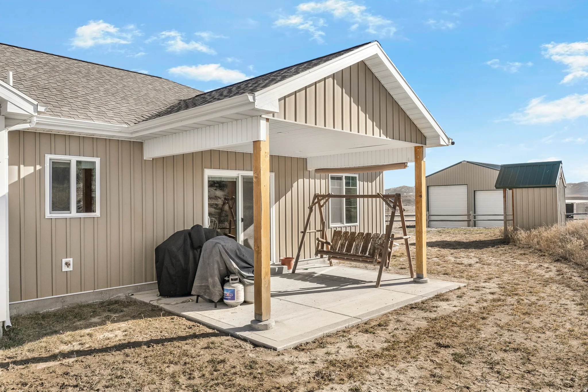 View of patio featuring an outbuilding and a detached garage