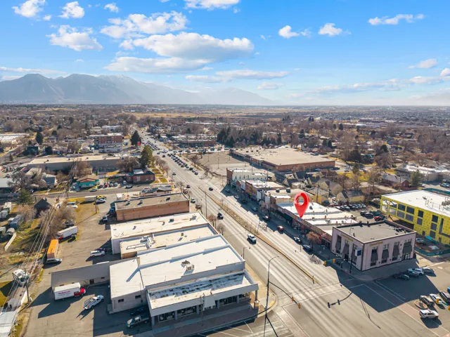 Drone / aerial view of industrial structures and a mountain backdrop