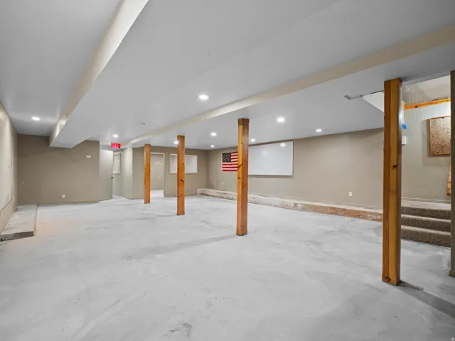 Finished below grade area with stairs and recessed lighting