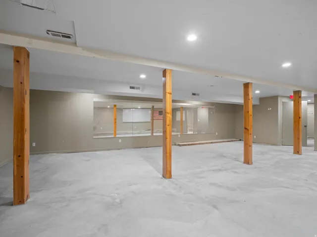 Finished basement featuring recessed lighting