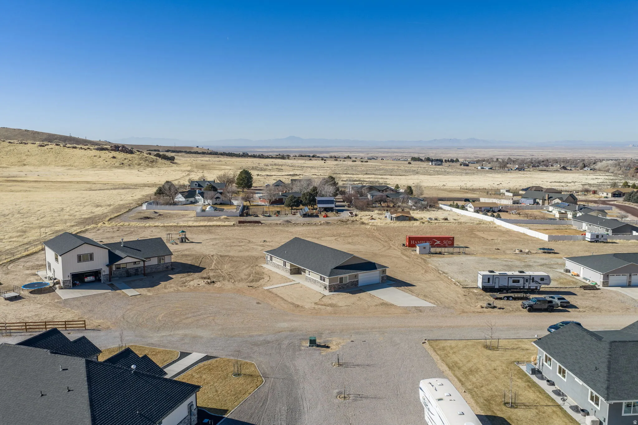 Overview of rural landscape with nearby suburban area and mountains