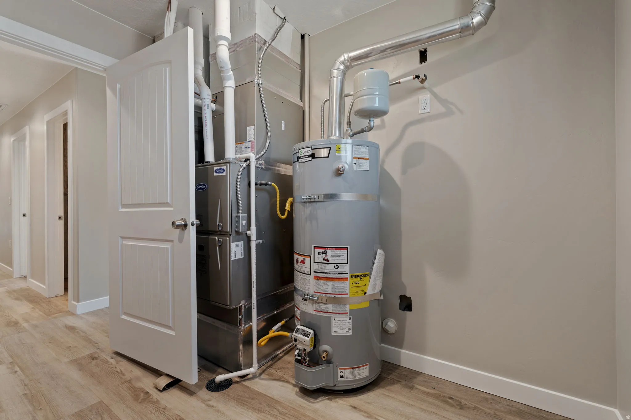 Utilities featuring heating unit and secured water heater in the large laundry room