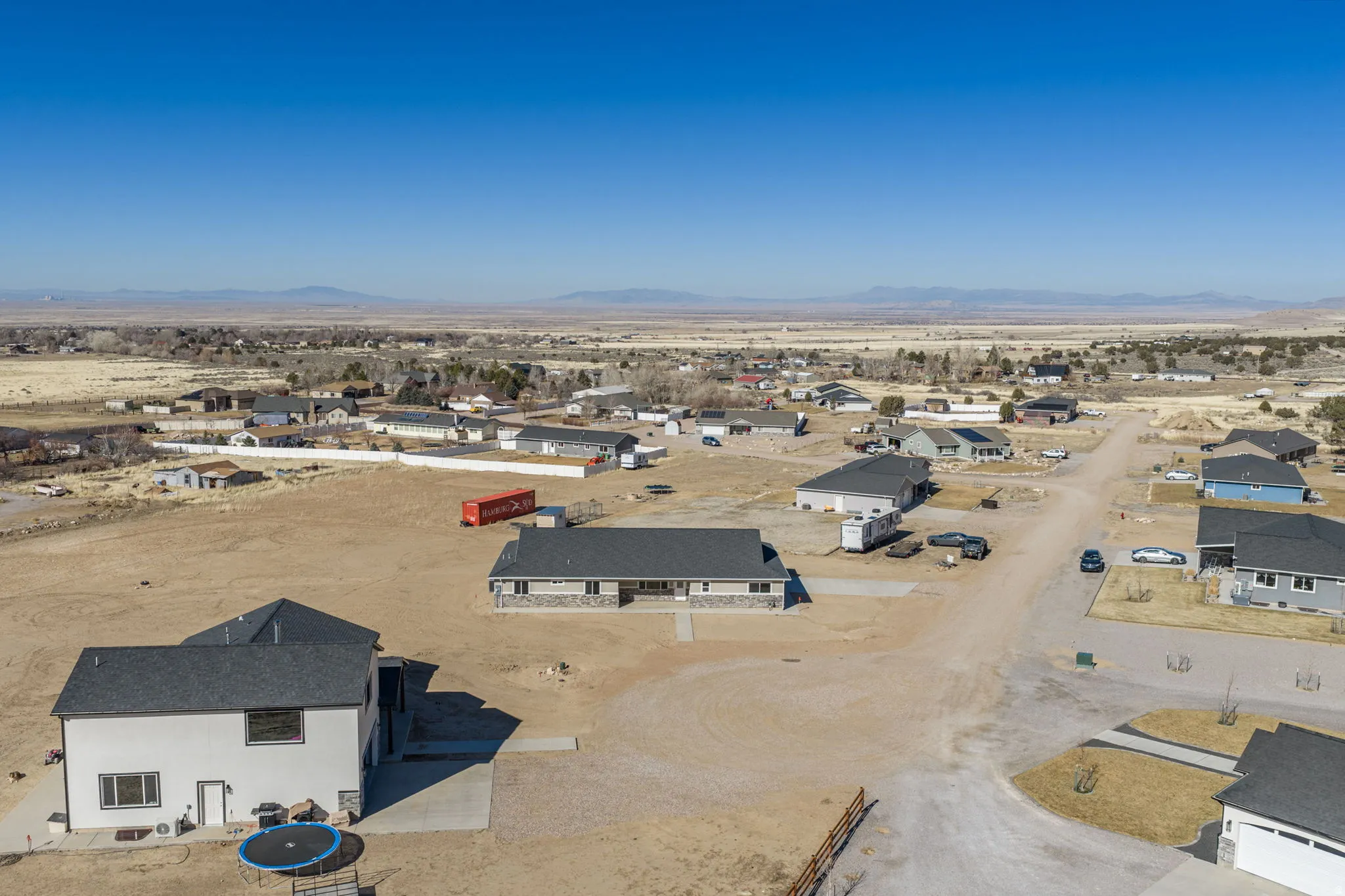 Aerial view of residential area with a desert landscape and mountains