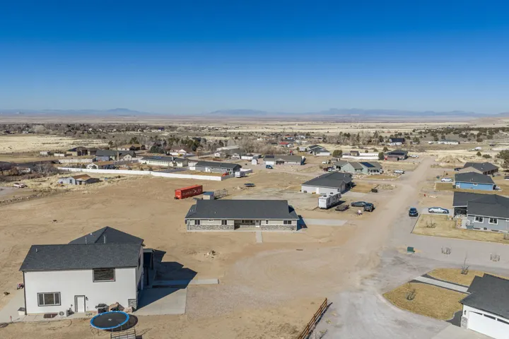 Aerial view of residential area with a desert landscape and mountains
