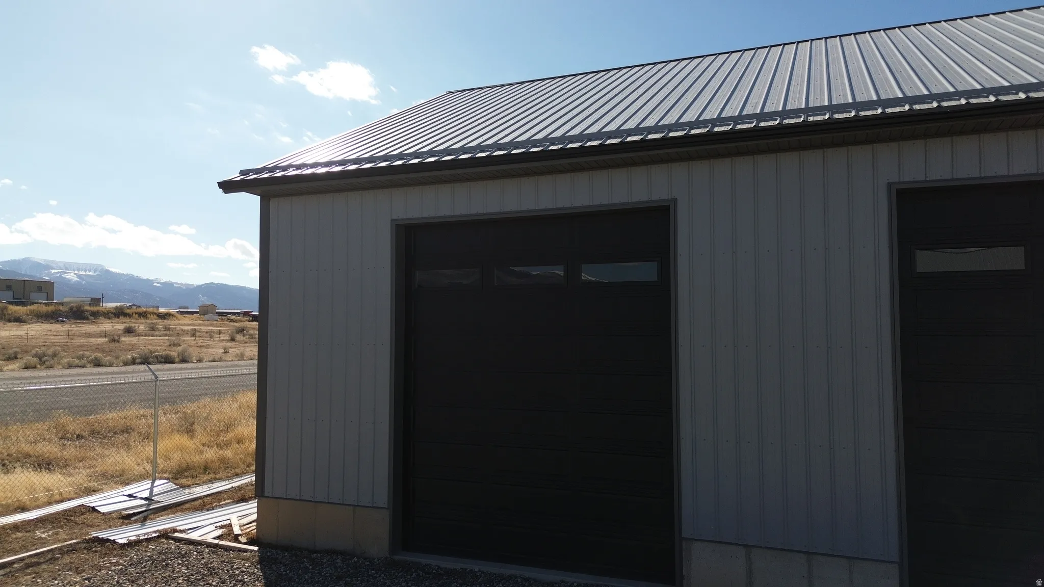 View of outbuilding with a mountain view and a garage
