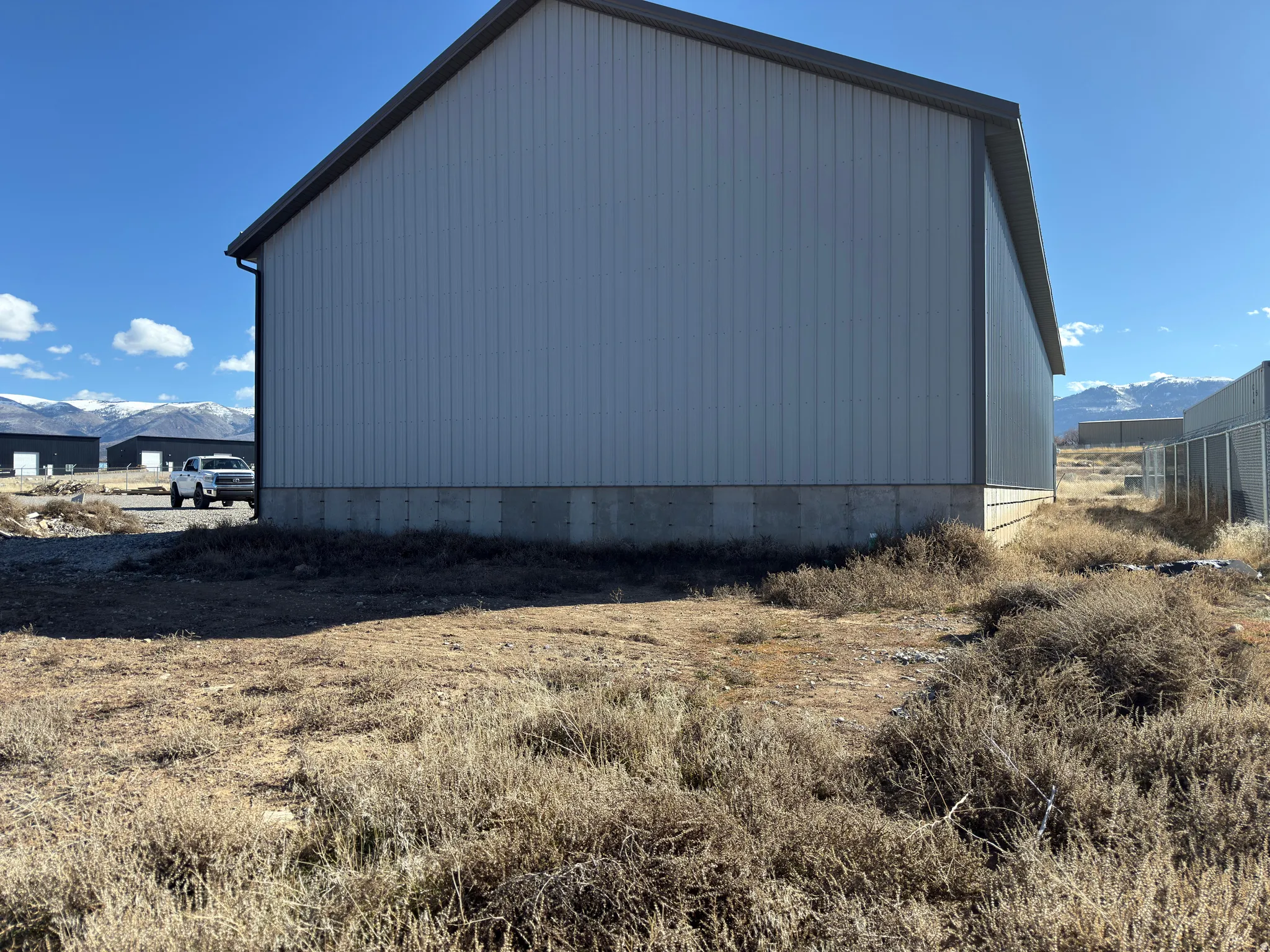 View of property exterior featuring a mountain view, an outbuilding, and an outdoor structure