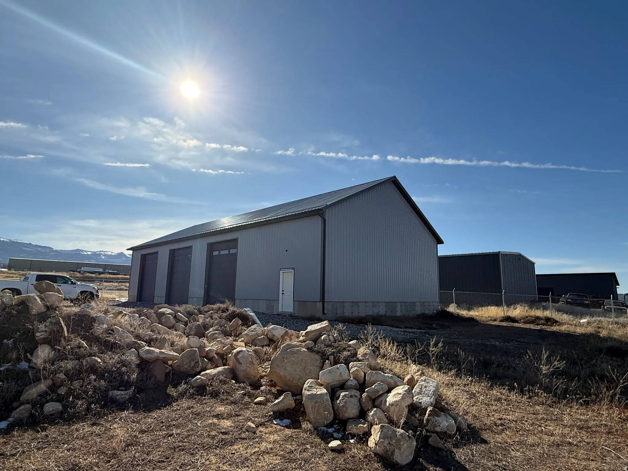 View of pole building with a mountain view