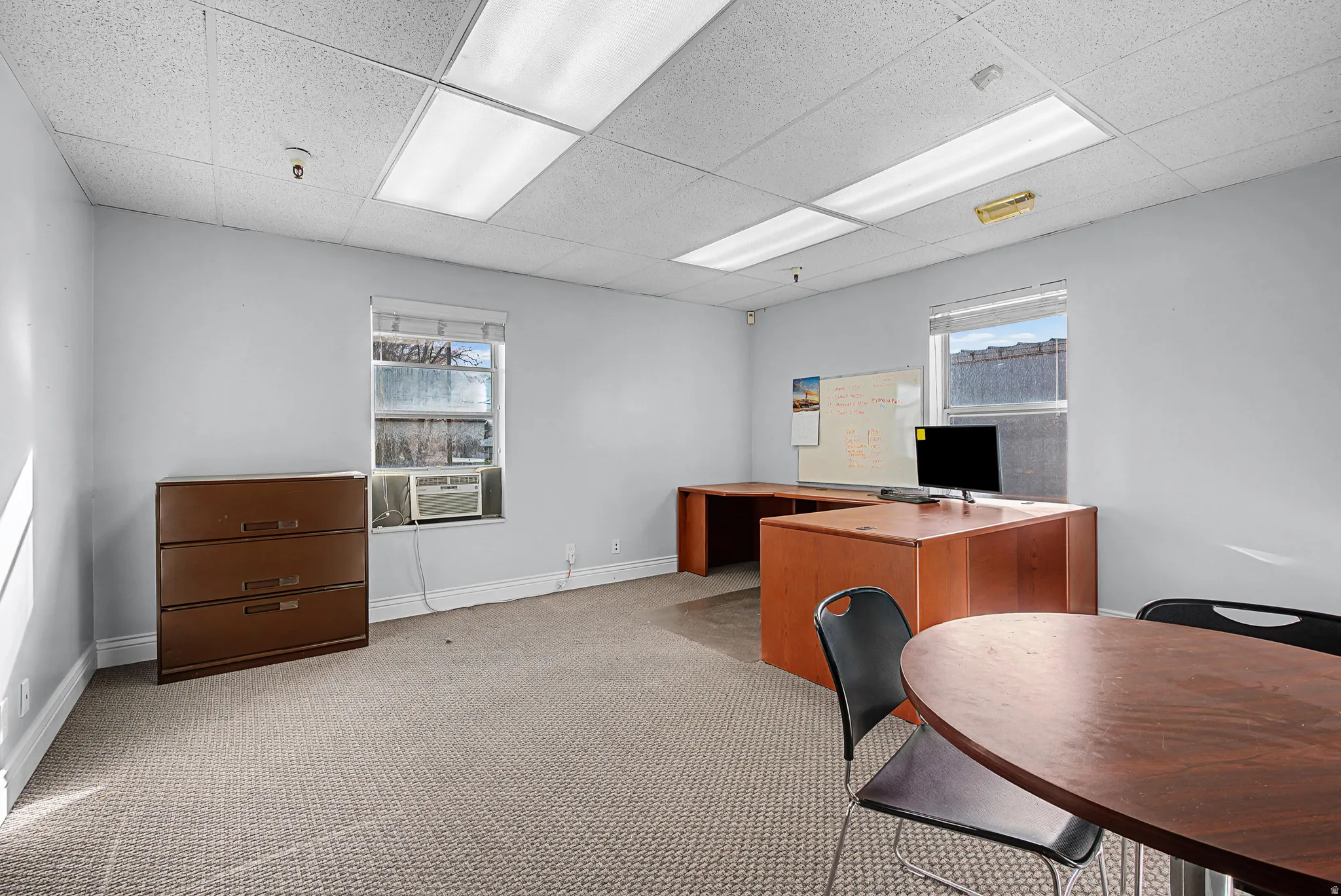 Home office with a paneled ceiling and plenty of natural light