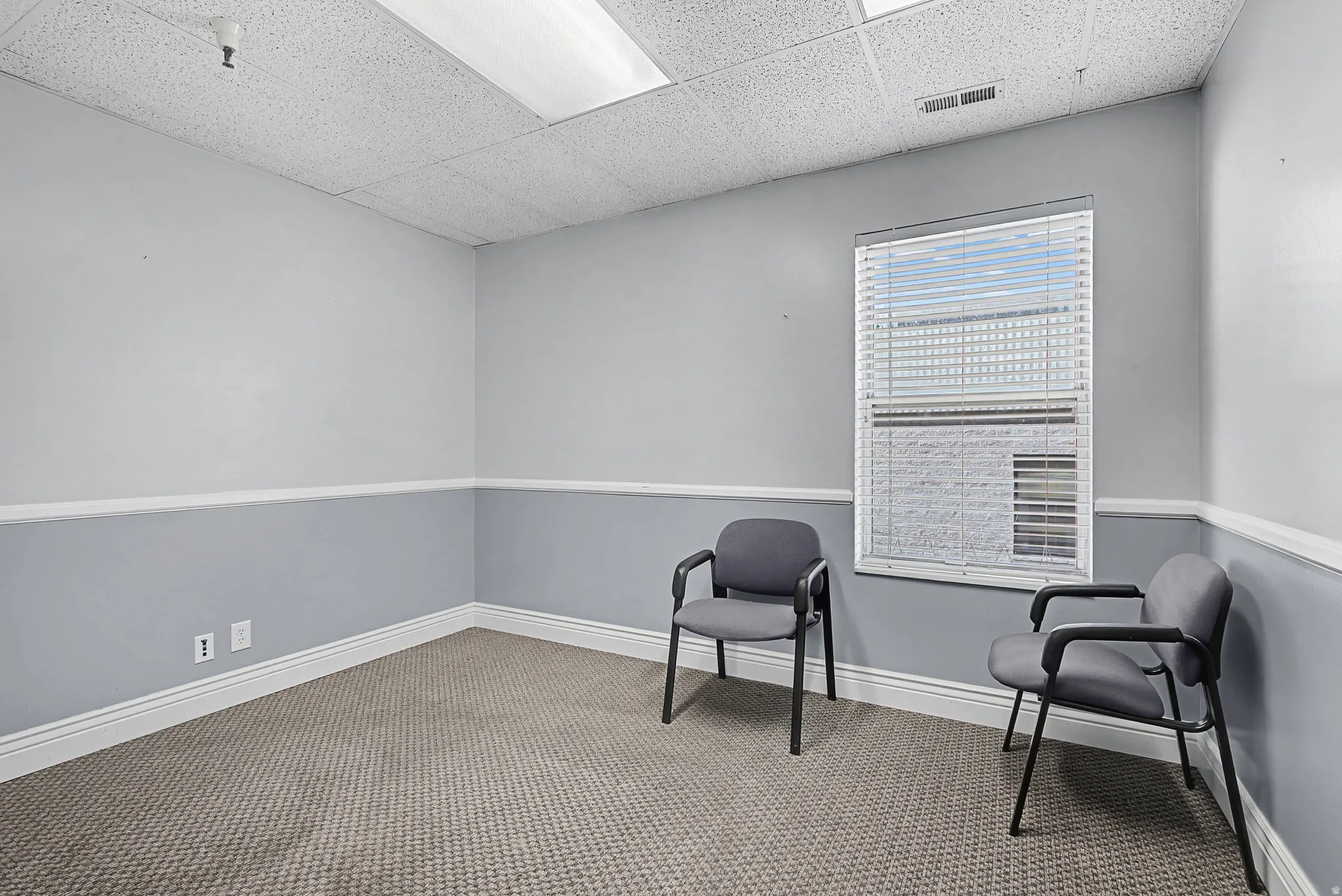 Unfurnished room with a paneled ceiling and carpet floors