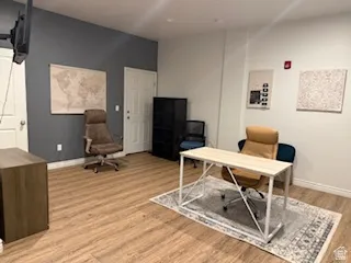 Office area with light wood-style floors and baseboards