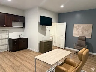 Office space with light wood-type flooring and recessed lighting