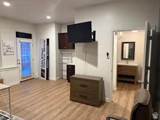 Kitchen featuring light wood finished floors, recessed lighting, and dark wood finish cabinetry
